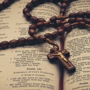 a rosary on top of an open Bible